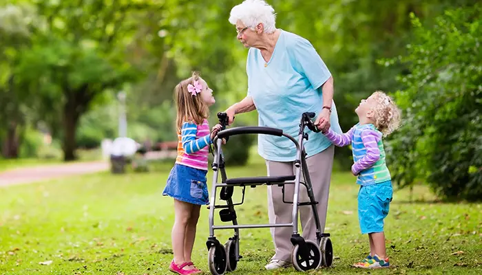 grandma walking with walker and grandchildren